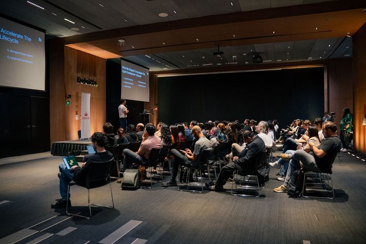 A full house at Deloitte University, the opening slide on screen.